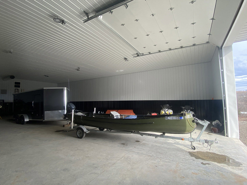 Trailer and canoe at inside storage facility at Caribou Storage Facility